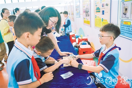 東暉小學五年級學生鄭昊宇（右）帶來了他制作的墻角照明防撞報警系統(tǒng)。