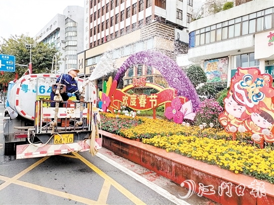 環(huán)衛(wèi)工人用心澆灌植物，擦亮城市容顏。